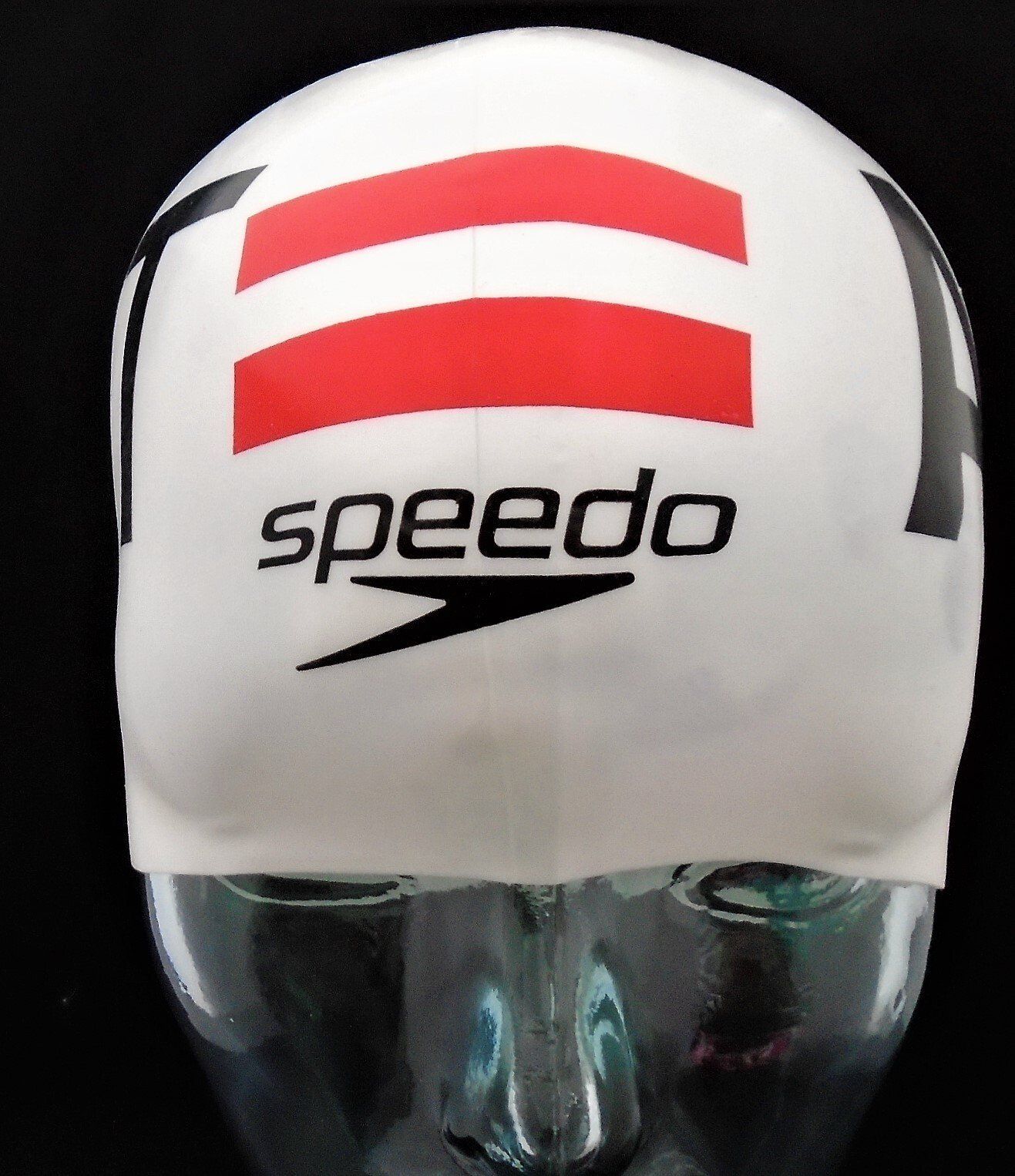 A speedo swim cap is on a mannequin head