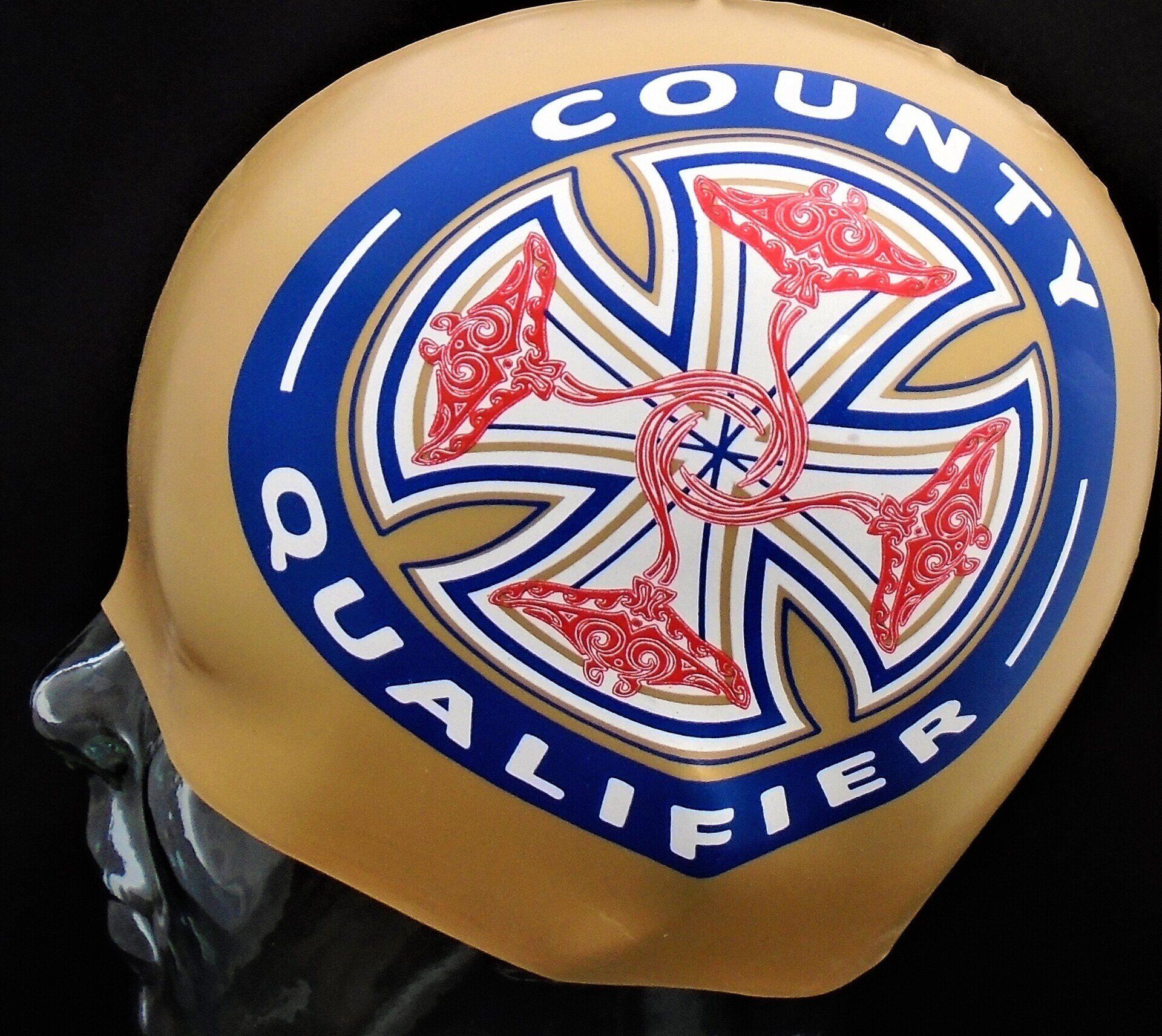 A swim cap that says county qualifier on it