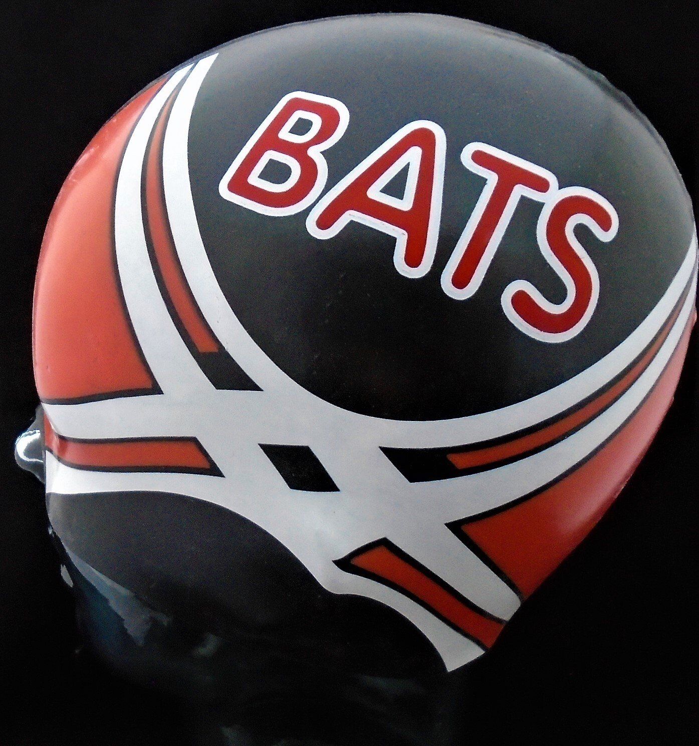 A black and red helmet with the word bats on it