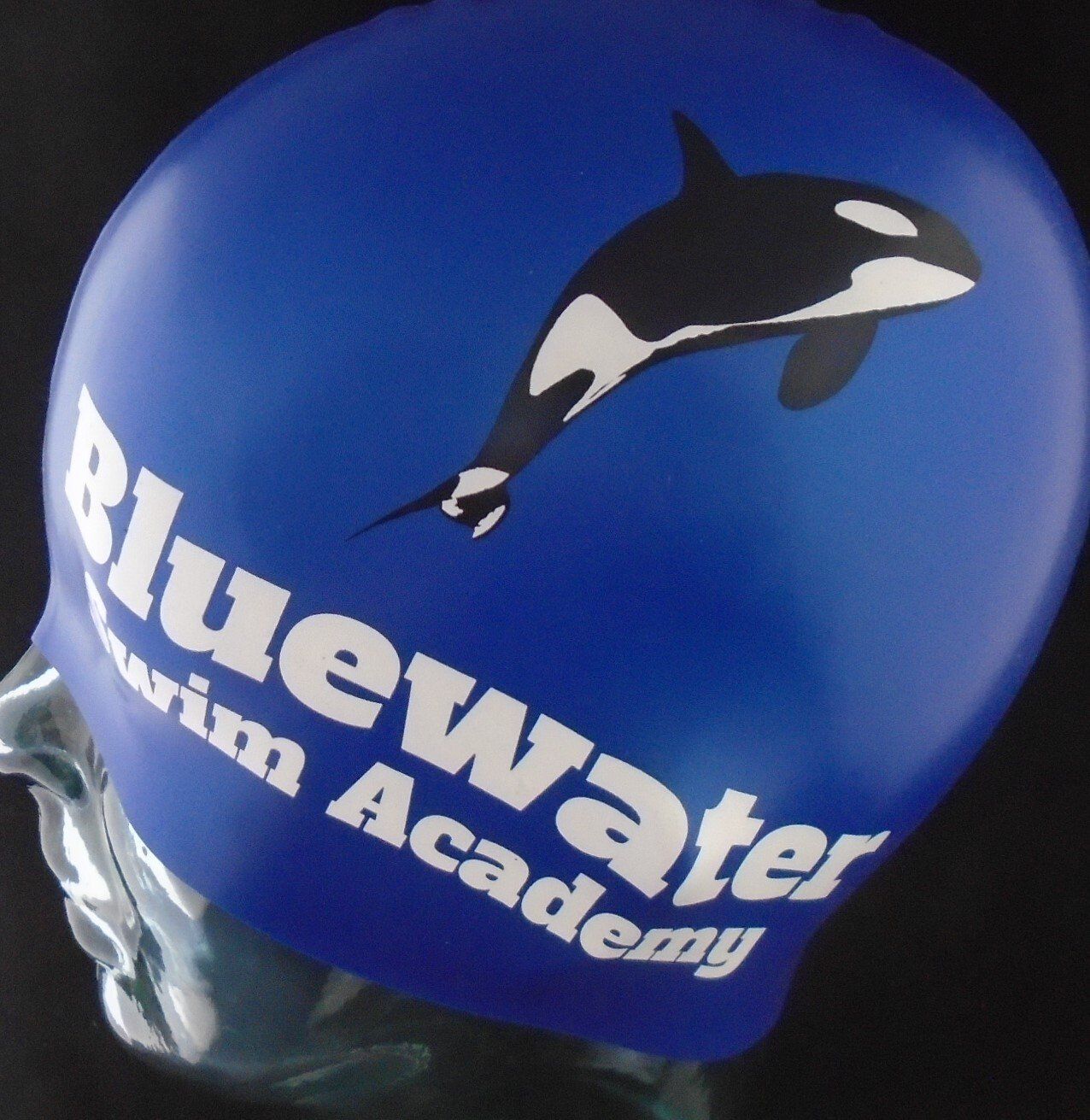 A blue swim cap for the bluewater swim academy
