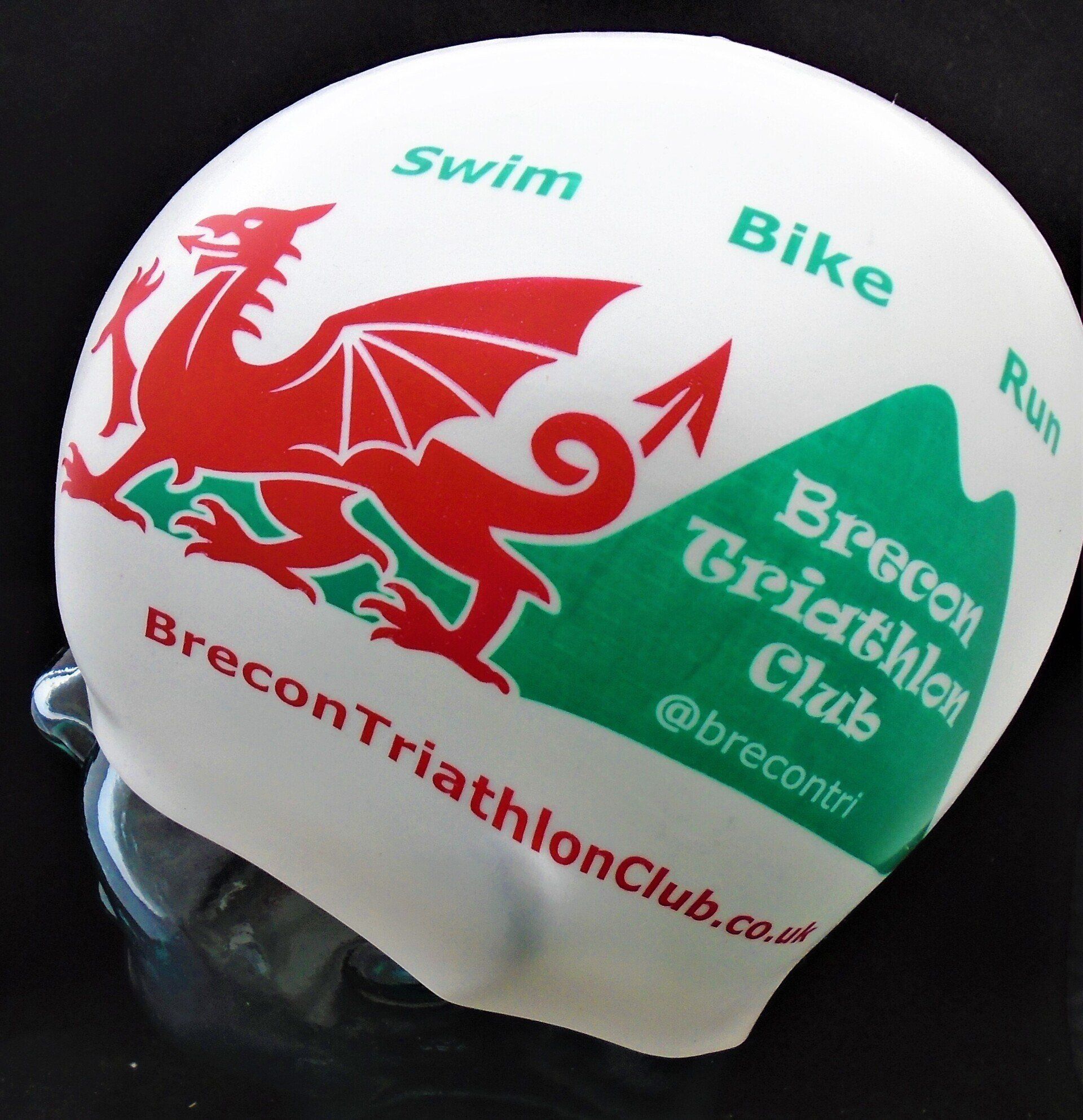 A swim cap with the brecon triathlon club logo on it