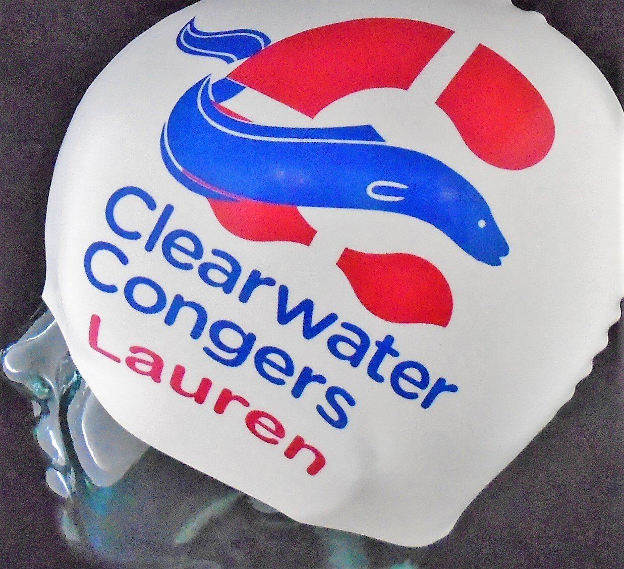 A swim cap that says clearwater congers lauren on it
