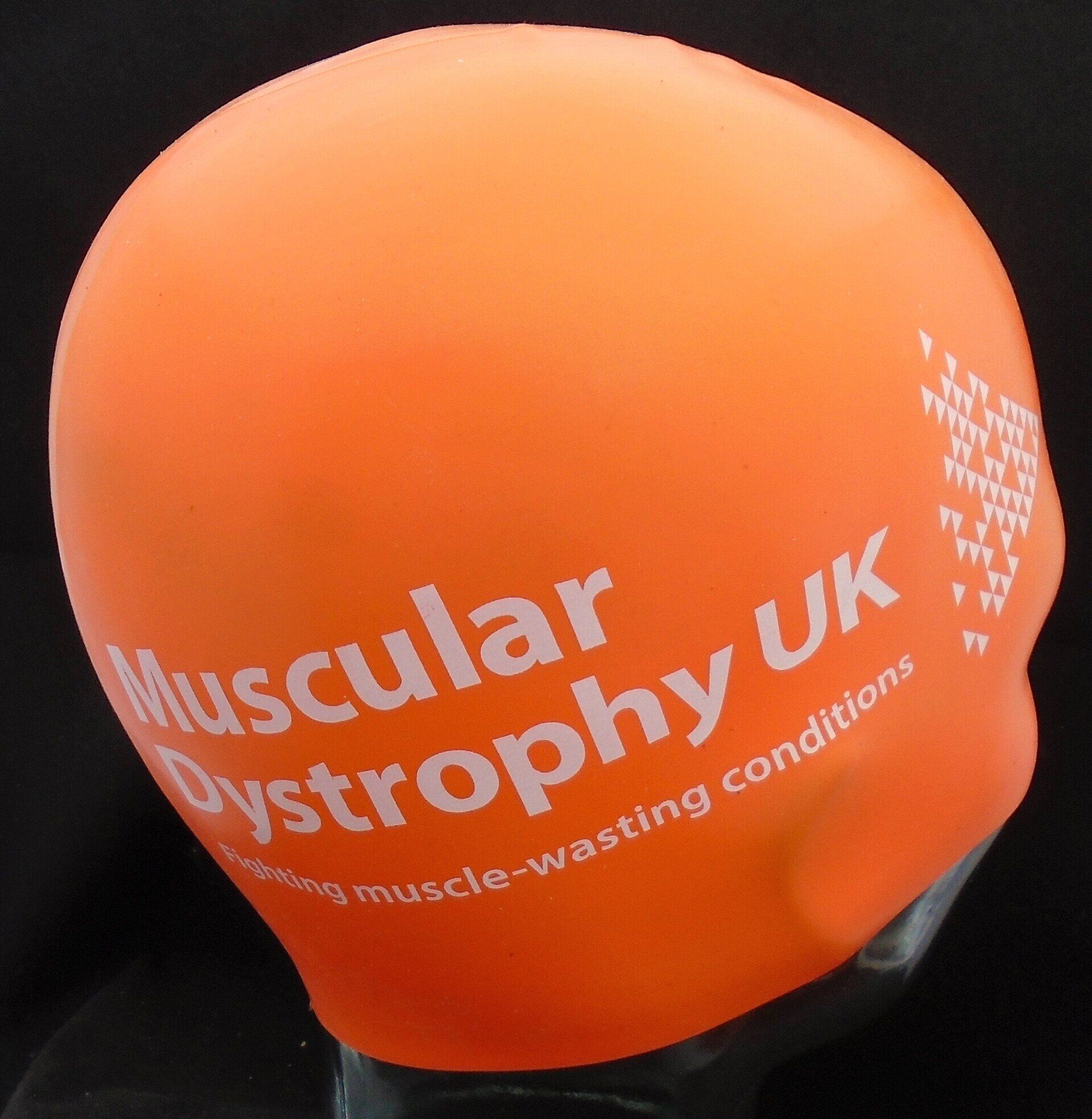 An orange swim cap that says muscular dystrophy uk