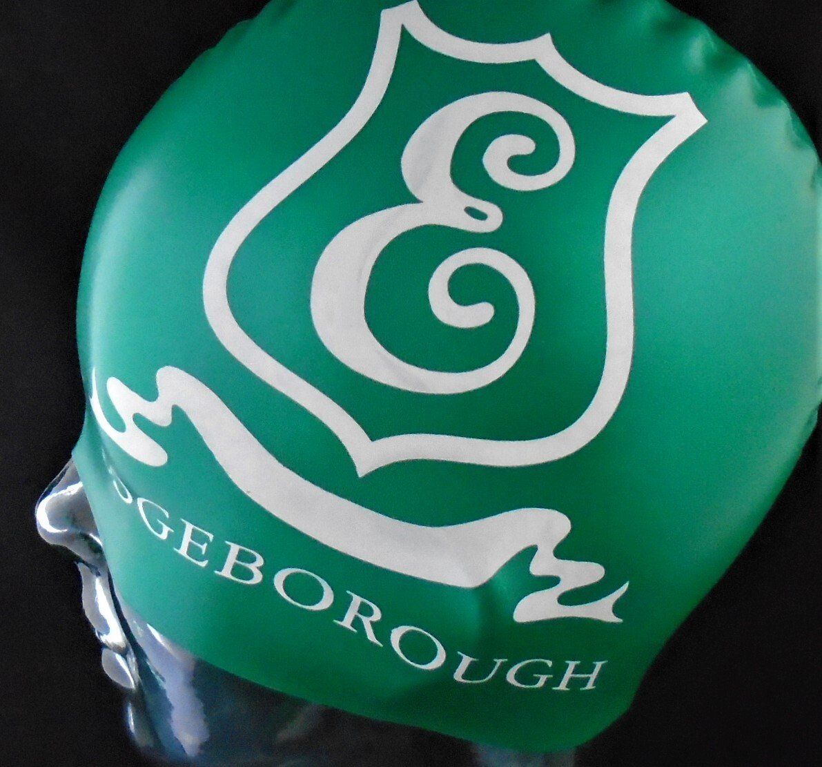 A green swim cap with the word geborough on it