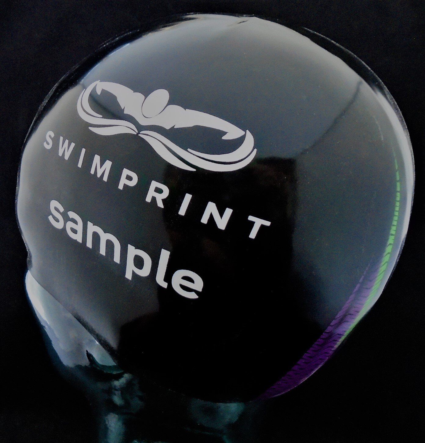 A black ball that says swimprint sample on it