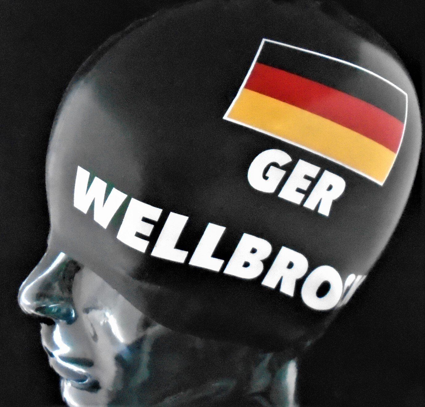 A black swim cap that says wellbro on it