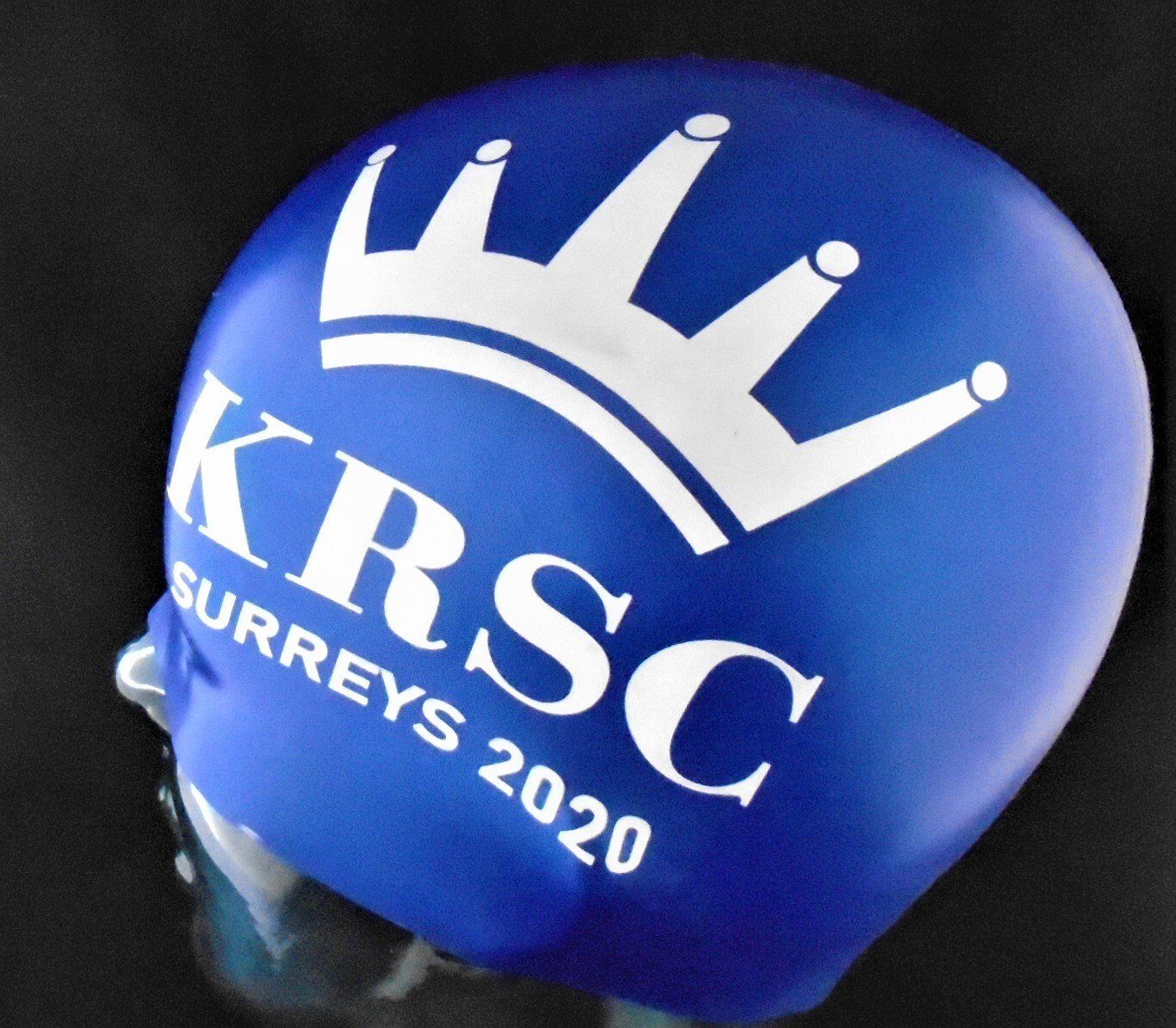 A blue swim cap with krsc surreys 2020 written on it