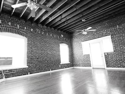 Living room with wood beam ceilings and hardwood floors