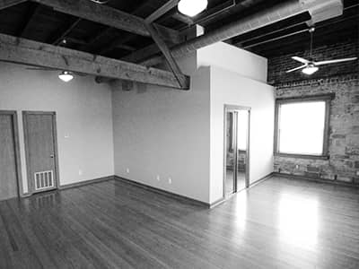 Living room with wood beam ceiling and exposed brick wall