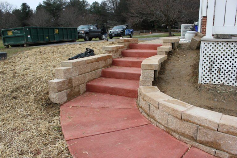red concrete stairs with 2 black cars in the back