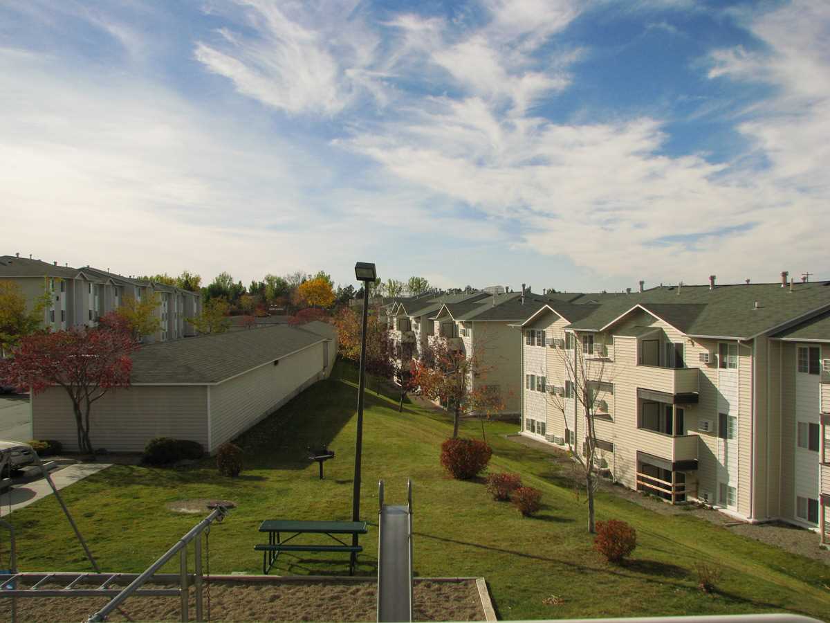 Exterior aerial view of grass area in between apartment buildings