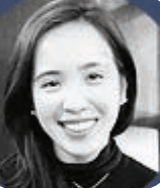Black-and-white portrait of a smiling person with short dark hair