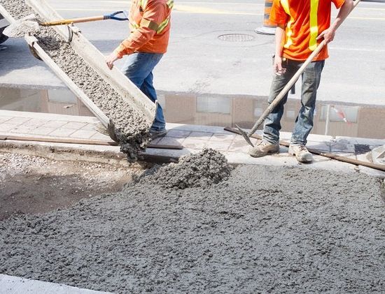 Operai al lavoro con il cemento