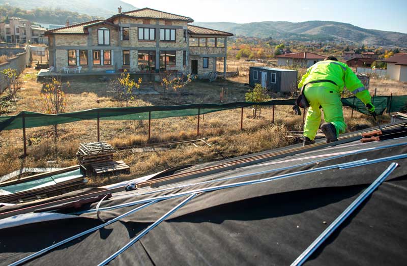 commercial roofing repair louisville ky worker on the roof
