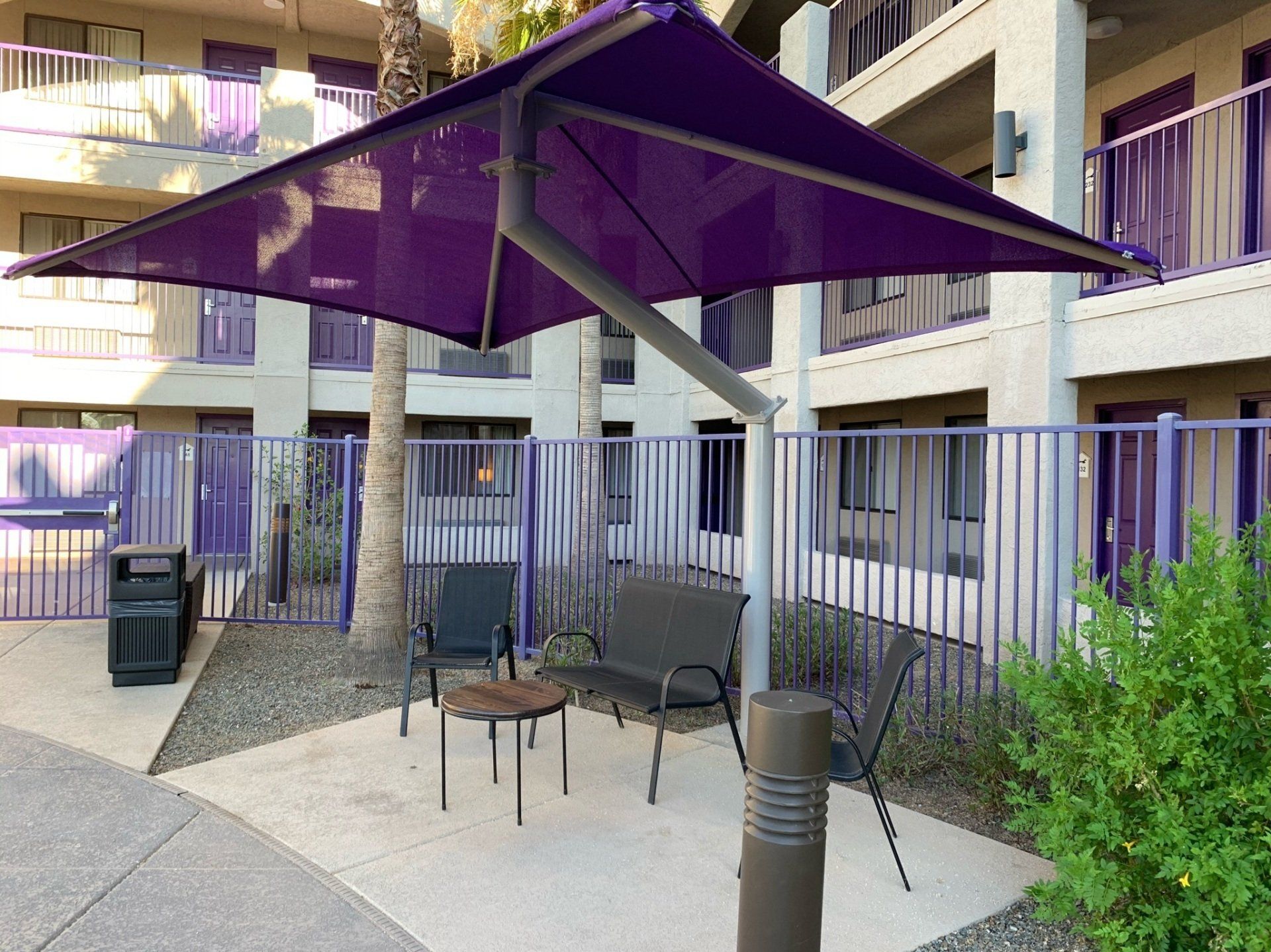 purple awning and shade covering fencing and table at apartment homes in Arizona