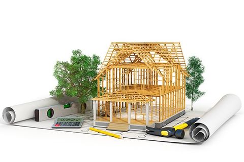 A rendering of a wood frame house on a set of plans.