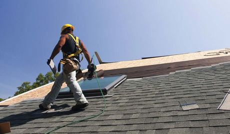 Roofer installing flashing on skylight — Roofing Professionals  Panama City, FL