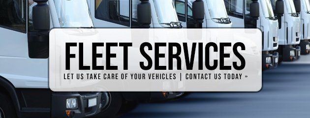 Fleet Services banner on white trucks, with text