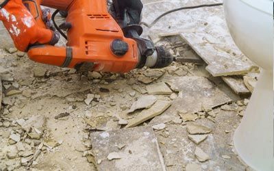 Floor Removal Company — Demolition of Old Tiles with Jackhammer in Jacksonville, FL Floor Removal Company — Demolition of Old Tiles with Jackhammer in Jacksonville, FL