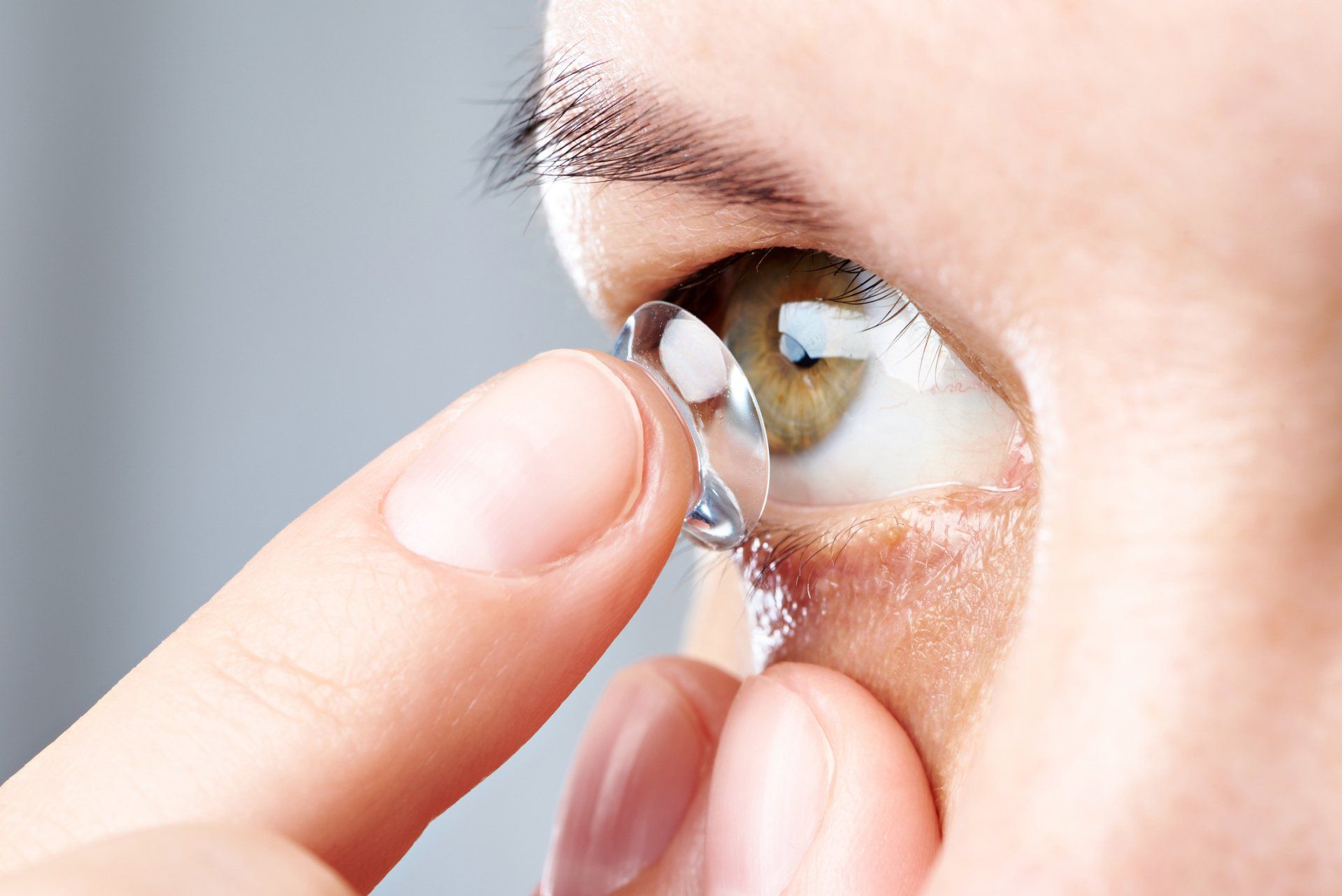Custom Fit Contacts — Woman Puts Contact Lens in Belleville, IL Custom Fit Contacts — Woman Puts Contact Lens in Belleville, IL
