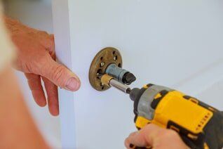 Making a hole for the lock — Mobile Locksmith in Moline, Illinios
