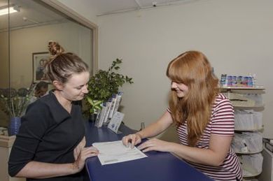 Receptionist checking patients details