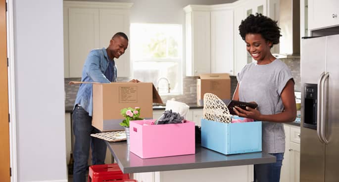 Young Couple Moving In To New Home Together