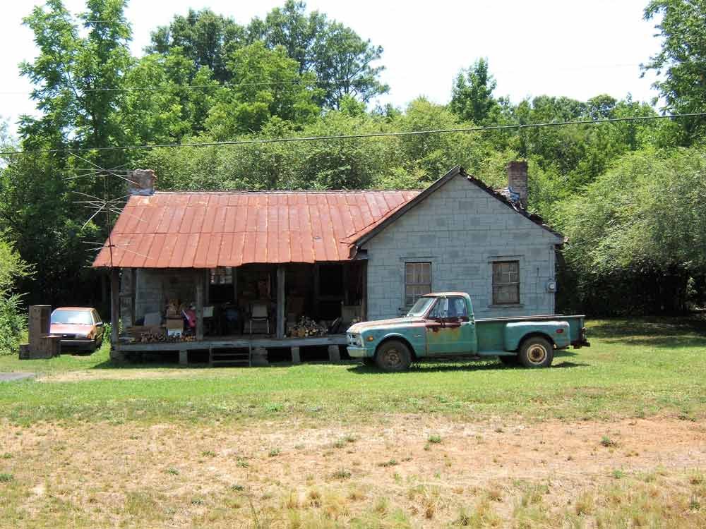 A truck is parked in front of an old house