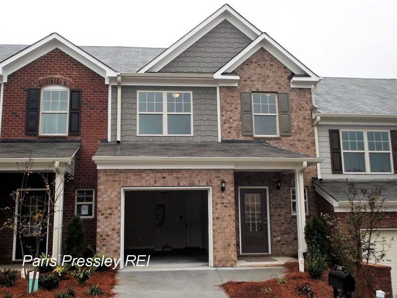 A large brick house with a garage for sale