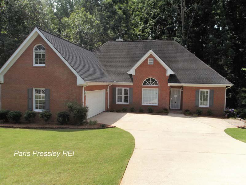 A brick house with a black roof is for sale by paris pressley rd