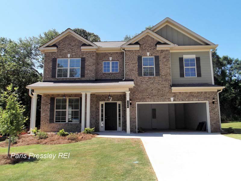 A large brick house with a garage is for sale by paris pressley