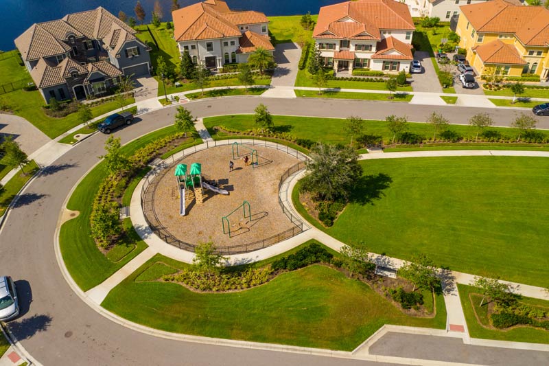 An aerial view of a residential neighborhood with a playground in the middle.