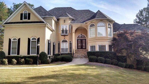 A large house with a lush green lawn in front of it