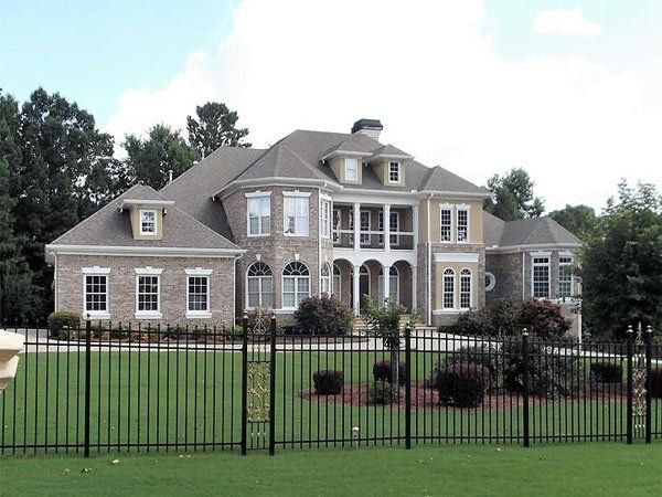 A large house with a black fence around it
