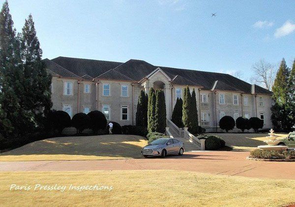 A large house with a car parked in front of it