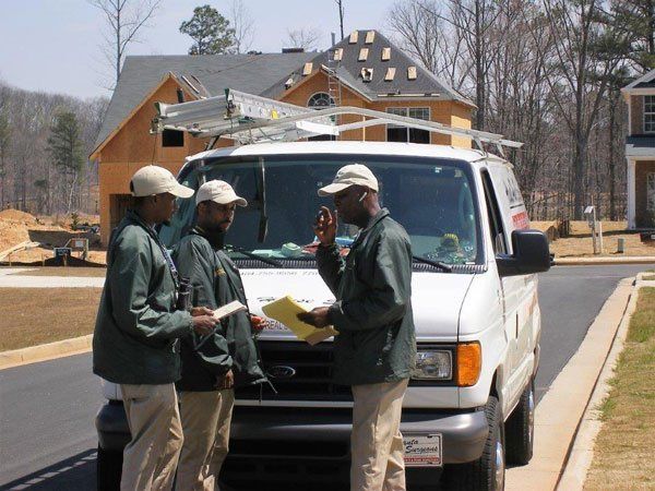 Three men are standing in front of a ford van