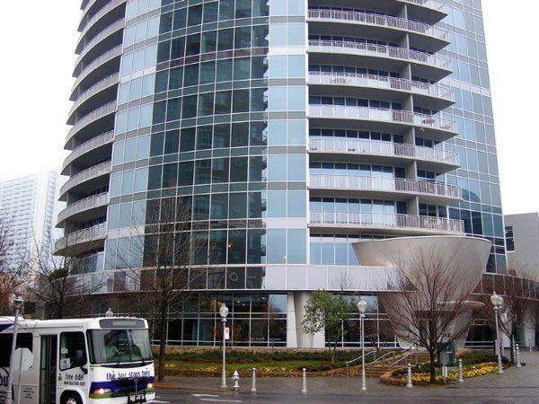 A bus is parked in front of a tall building