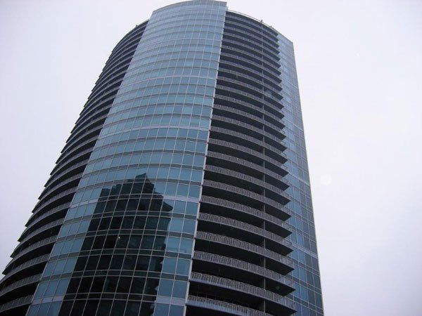 A tall building with a lot of windows and balconies