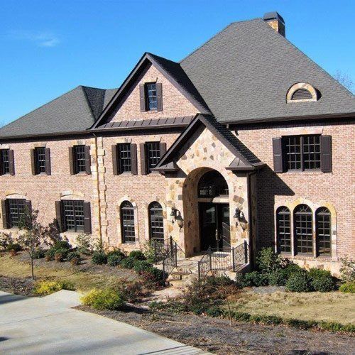 A large brick house with a gray roof