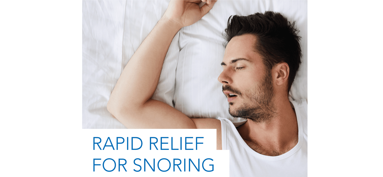 A man is sleeping on a bed with his eyes closed.