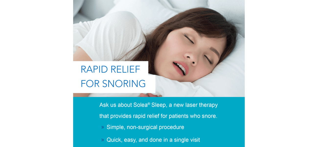 A woman is sleeping in a bed with her eyes closed.