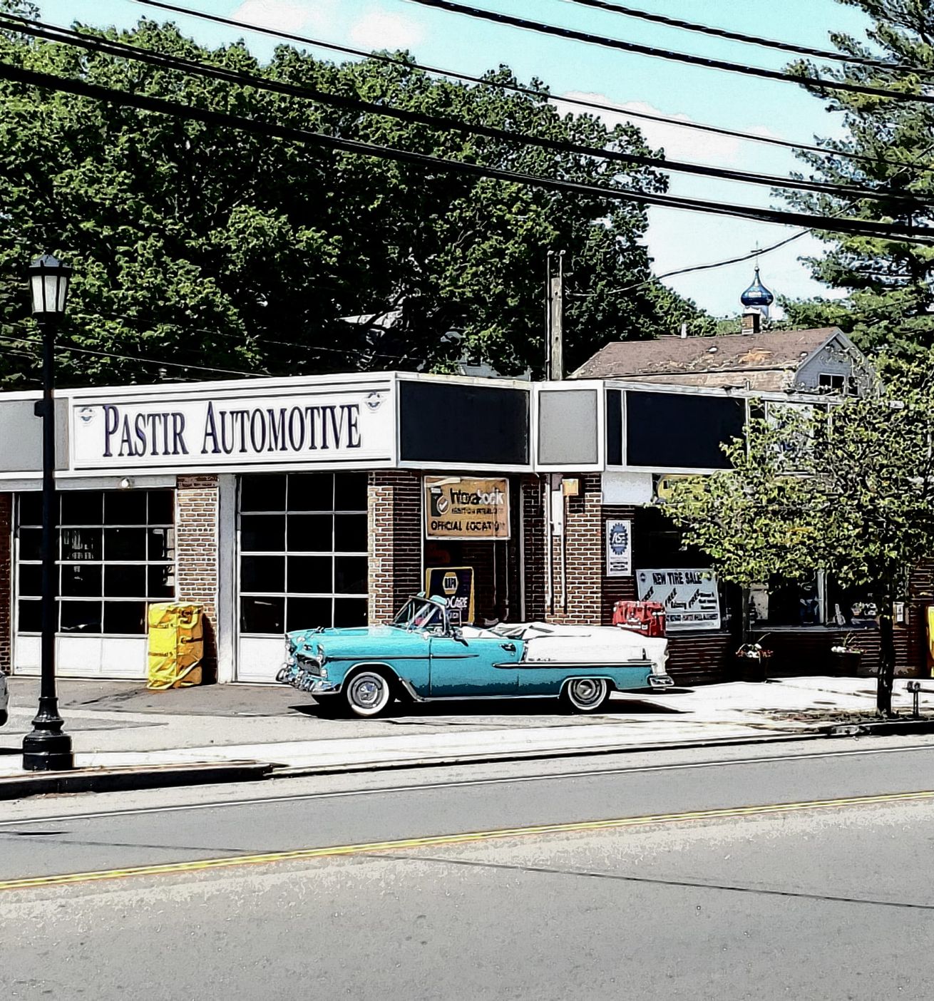 A blue convertible parked in front of 