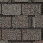Dark grey asphalt roofing shingles.