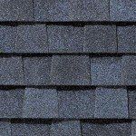 Dark blue asphalt roof shingles, overlapping pattern.