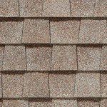 Brown asphalt roof shingles in a repeating pattern.