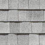 Gray asphalt roof shingles in a repeating pattern.