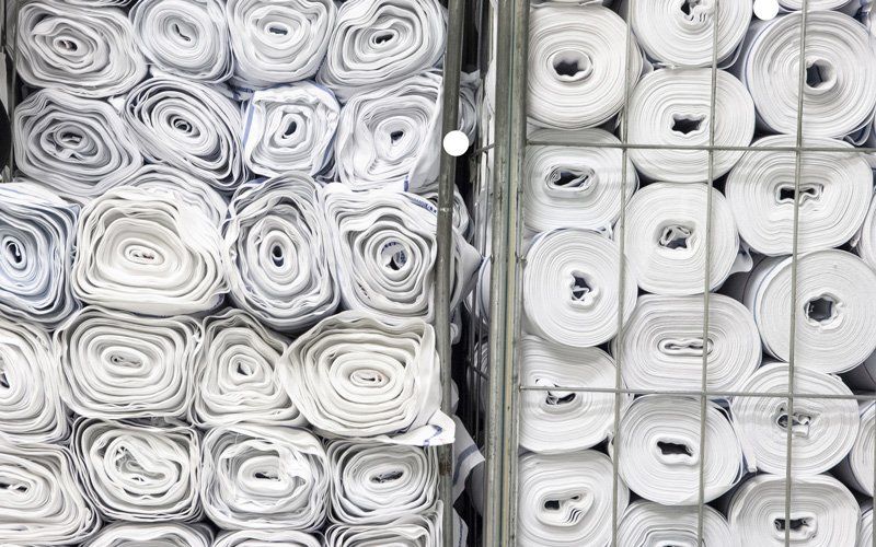 Rolls Of White Fabric Stored In Warehouse — Dallas, TX — Pacific Rope and Tarp Company Rolls Of White Fabric Stored In Warehouse — Dallas, TX — Pacific Rope and Tarp Company