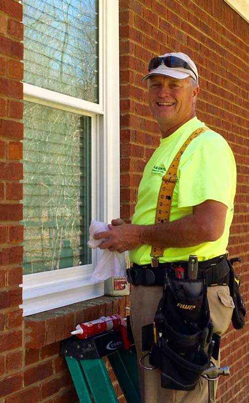 Man Installing Windows - Vinyl Window Installation in Huntsville, Al Man Installing Windows - Vinyl Window Installation in Huntsville, Al