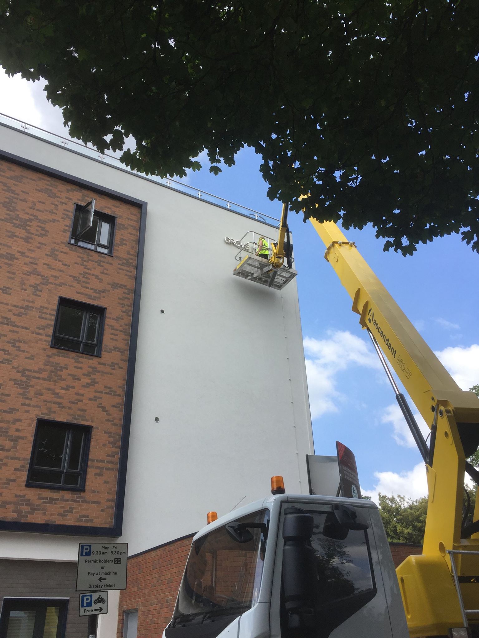 Cherry picker accessing third floor on high rise building