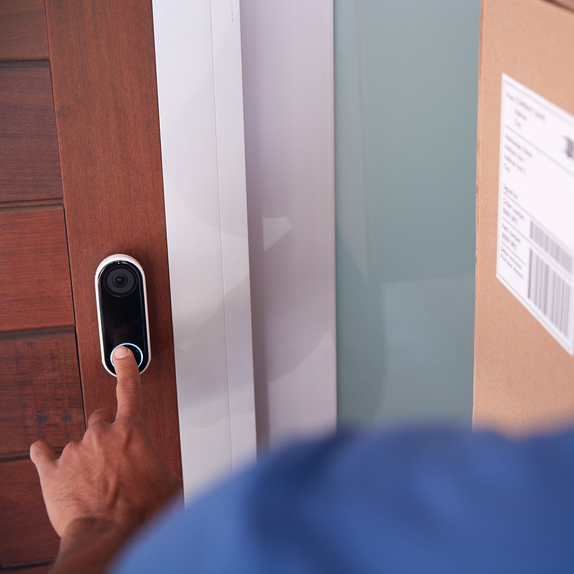 Picture of delivery man pressing doorbell camera